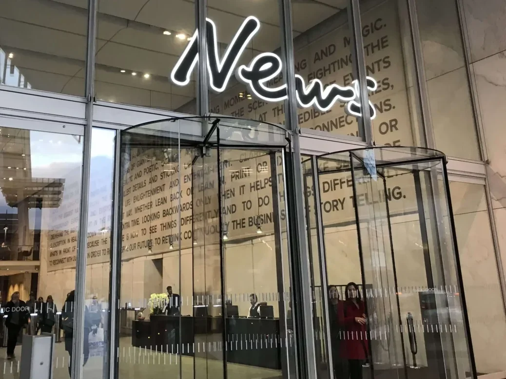 Entrance to News UK building with glass walls, revolving doors and a big sign saying 'News' over the doors, illustrating a story about Dow Jones recognising the News UK funded 'News Union' as NUJ talks were set to go to the CAC.