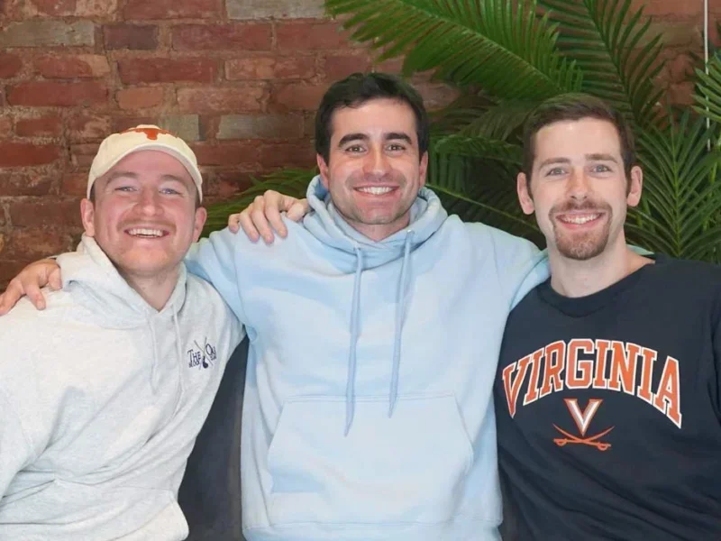 RocaNews co-founders. Picture shows three men in approximately their late 20s/early 30s with their arms around each other and smiling towards the camera